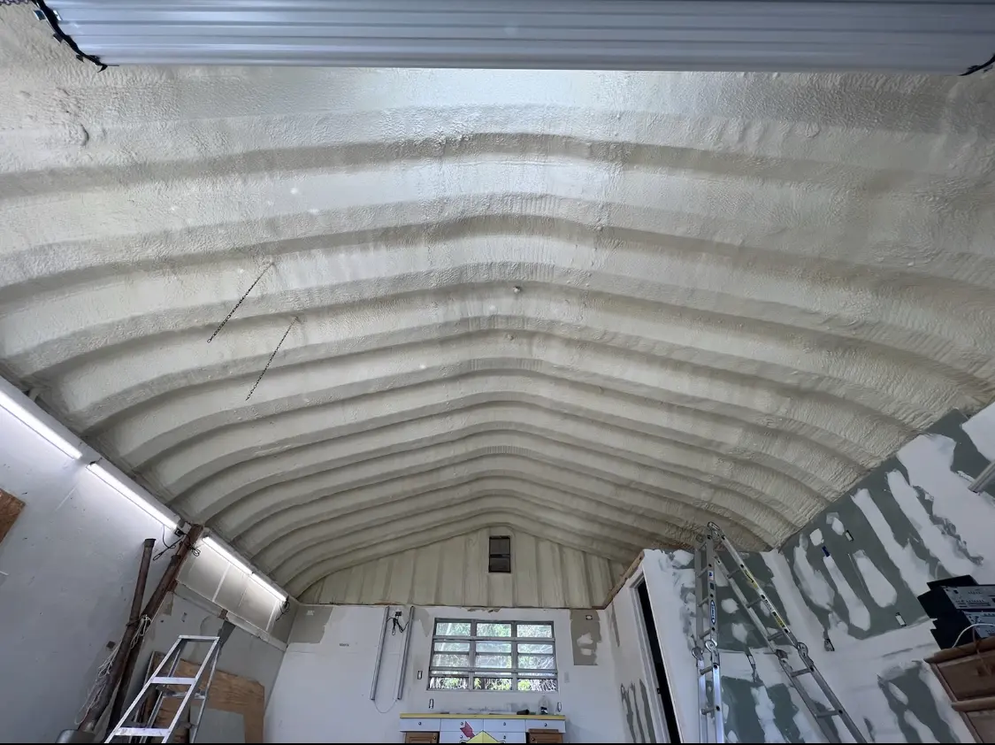 Spray polyurethane foam applied to the underside of a metal roof deck in Natick